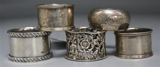 Five assorted silver napkin rings.